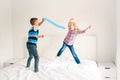 Children jumping on bed in bedroom and playing