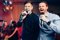 Two caucasian friends men in karaoke Royalty Free Stock Photo