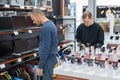 Two Caucasian men choose smartwatches in a tech store. Royalty Free Stock Photo