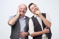 Two caucasian men laughing on his friends joke Royalty Free Stock Photo