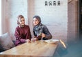 Two caucasian muslim woman drinking tea in cafe Royalty Free Stock Photo