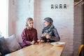 Two caucasian muslim woman drinking tea in cafe Royalty Free Stock Photo