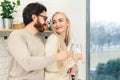 two caucasian people celebrating their relationship and drinking champagne from beautiful glasses while standing next to Royalty Free Stock Photo