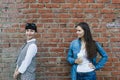 Two caucasian women girlfriends stand on grange red brick wall background Royalty Free Stock Photo