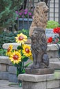 Two Big Cat Lion Sculptures in Garden with Sunflowers Royalty Free Stock Photo