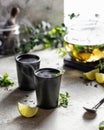 Two ceramic cups of hot lemon tea with steam and a teapot, cozy morning composition