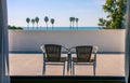 Two chair at balcony with the view of beautiful beach and blue sea Royalty Free Stock Photo