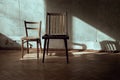 Two chairs in an abandoned room. Light rays and shadows on the wall. Royalty Free Stock Photo