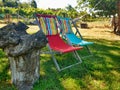 Two chairs two colors setting in the garden with coloured sunbathing cushions Royalty Free Stock Photo