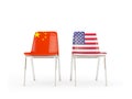 Two chairs with flags of China and US isolated on white