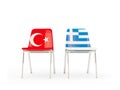 Two chairs with flags of Turkey and greece isolated on white