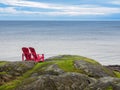 Two chairs overlooking ocean shore