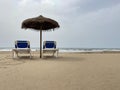 Two Chairs And A Parasol With Sea Bottom. Beach and summer vacation concept