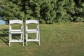 Two chairs placed on a green lawn set up for an outdoor wedding ceremony Royalty Free Stock Photo