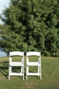 Two chairs placed on a green lawn set up for an outdoor wedding ceremony Royalty Free Stock Photo