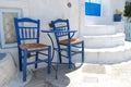 Two chairs on a street in Pyrgos Santorini