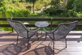 Two chairs and table on the backyard in tropical garden with beautiful view Royalty Free Stock Photo