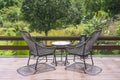 Two chairs and table on the backyard in tropical garden with beautiful view Royalty Free Stock Photo