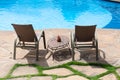 Two chairs and table in front of swimming pool deck in a hotel Royalty Free Stock Photo