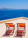 Two chairs on terrasse and amazing Santorini volcano view. Santorini, Greece Royalty Free Stock Photo