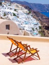 Two chairs on terrasse and amazing Santorini volcano view. Santorini, Greece Royalty Free Stock Photo