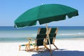 Two chairs and umbrella on white sand beach Royalty Free Stock Photo