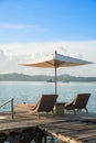 Two chairs and umbrella on wooden desk in resort ,Phuket Royalty Free Stock Photo