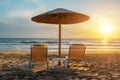 Two chairs under beach umbrella on tropical beach during sunset. Summer vacation concept Royalty Free Stock Photo