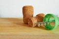 Two champagne corks and a corkscrew are lying on a wooden table. Close-up. Royalty Free Stock Photo