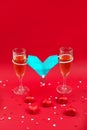 Two champagne glases, candy and medical mask valentine