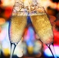 Two champagne glasses against bright lights Royalty Free Stock Photo