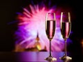 two champagne glasses against holiday lights and fireworks - new year celebration Royalty Free Stock Photo