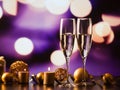 two champagne glasses against holiday lights and fireworks - new year celebration Royalty Free Stock Photo