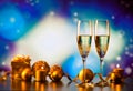 two champagne glasses against holiday lights and fireworks - new year celebration Royalty Free Stock Photo