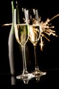 Two champagne glasses and bottle in front of fireworks on black background Royalty Free Stock Photo