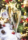 Two champagne glasses and christmas decoration over blue snow golden bokeh background. Happy New Year Celebration. Selective focus Royalty Free Stock Photo