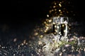 Two champagne glasses and christmas decoration over dark golden bokeh background Royalty Free Stock Photo