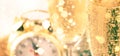 Two champagne glasses and christmas decoration over gray golden bokeh background. Happy New Year Celebration. Selective focus and