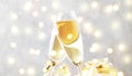 Two champagne glasses and christmas decoration over gray golden bokeh background. Happy New Year Celebration. Selective focus and Royalty Free Stock Photo