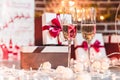 Two champagne glasses in front of christmas presents Royalty Free Stock Photo