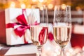 Two champagne glasses in front of christmas presents Royalty Free Stock Photo