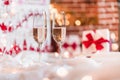 Two champagne glasses in front of christmas presents Royalty Free Stock Photo