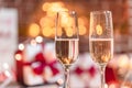 Two champagne glasses in front of christmas presents Royalty Free Stock Photo