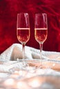 Two champagne glasses in front of red background Royalty Free Stock Photo