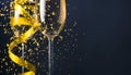 Two champagne glasses with golden ribbon and gold glitter splash bokeh on dark background. Luxury restaurant dinner celebration. Royalty Free Stock Photo