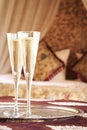 Two champagne glasses with oriental canopy bed at the background Royalty Free Stock Photo