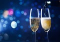 two champagne glasses ready to bring in the New Year - holiday lights and fireworks in the background Royalty Free Stock Photo