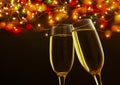 two champagne glasses ready to bring in the New Year - holiday lights and fireworks in the background Royalty Free Stock Photo