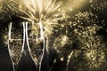 two champagne glasses ready to bring in the New Year - holiday lights and fireworks in the background Royalty Free Stock Photo