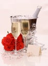 Two champagne glasses, red roses. golden wedding rings Royalty Free Stock Photo